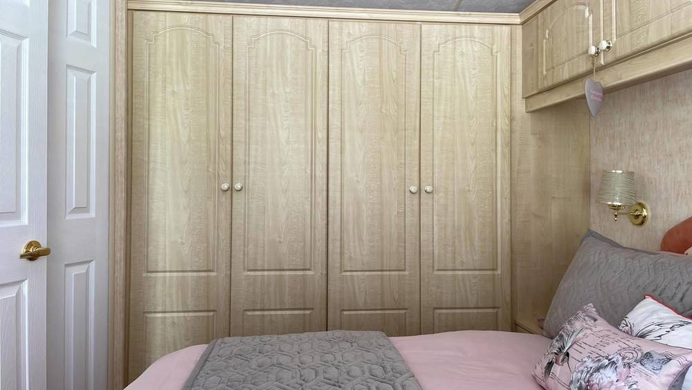 Caravan bedroom wardrobes in oak effect, before