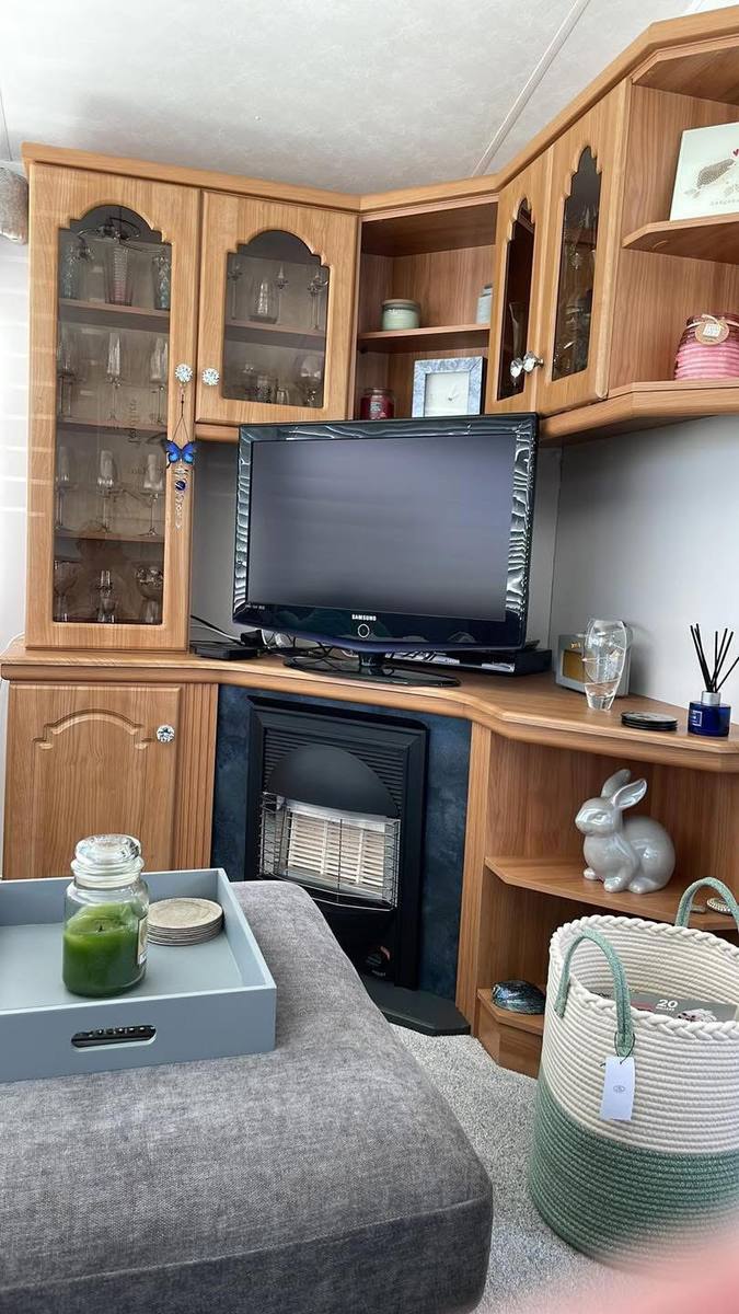 Wood-effect display unit in a caravan living room, before