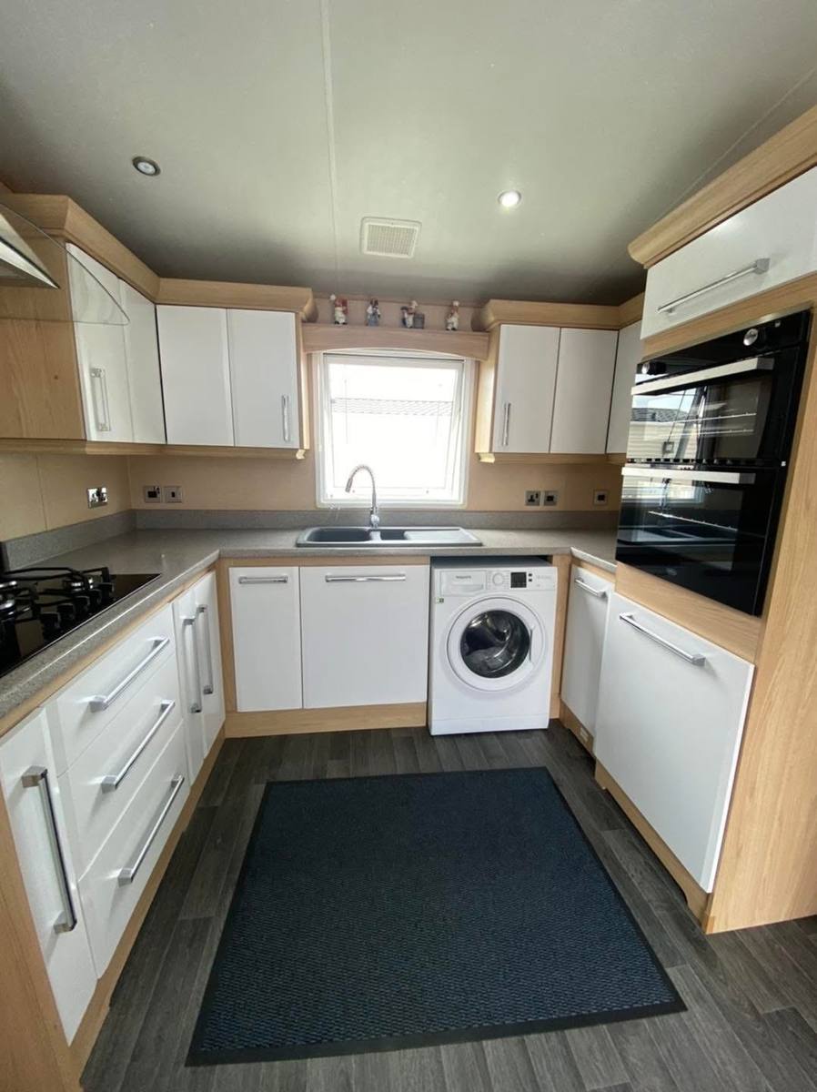The same kitchen with the doors repaired and painted white gloss