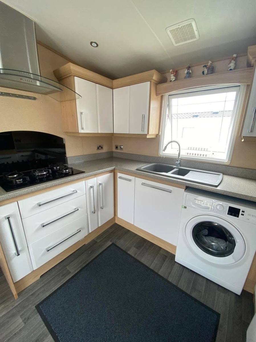 The same kitchen with the doors painted gloss white
