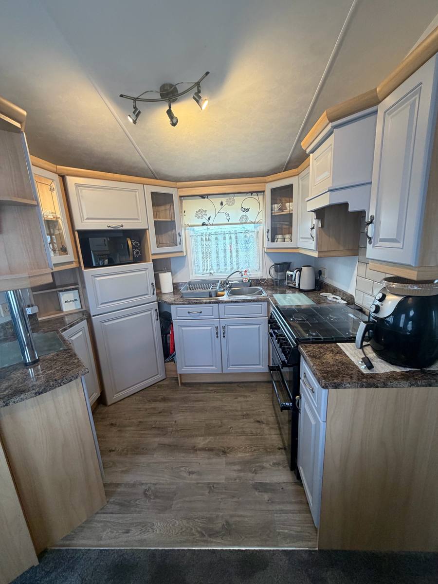 The same kitchen with the units painted light grey