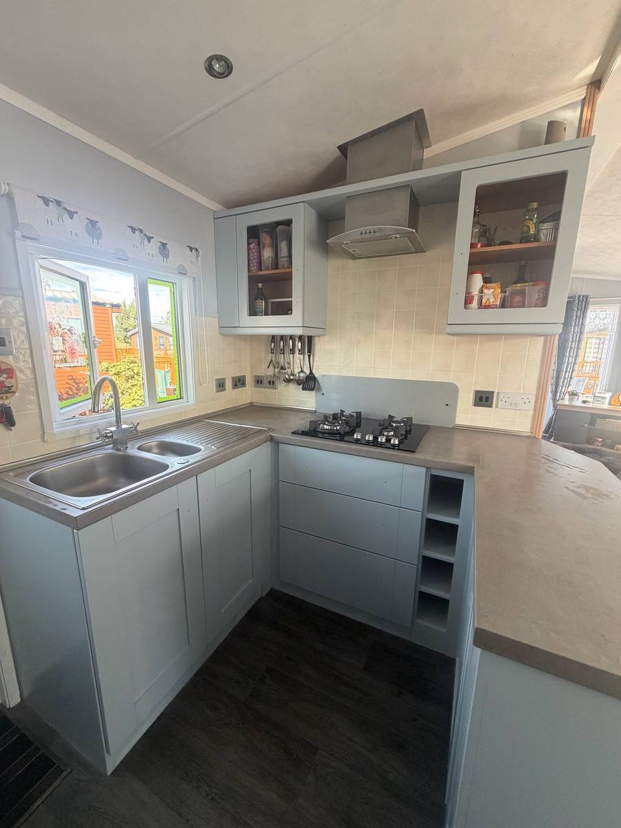 The same kitchen with the doors painted pale grey-blue