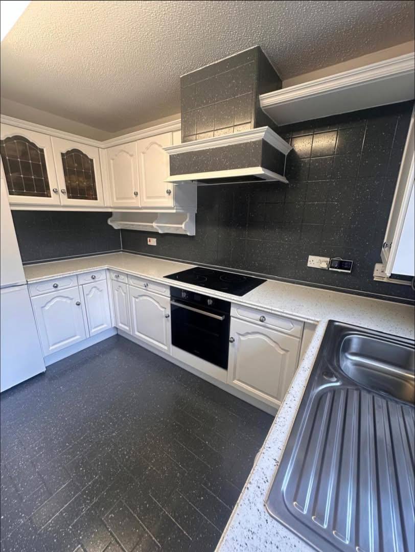The same kitchen fully transformed: units painted, new-look worktops, wall tiles and floor tiles refinished